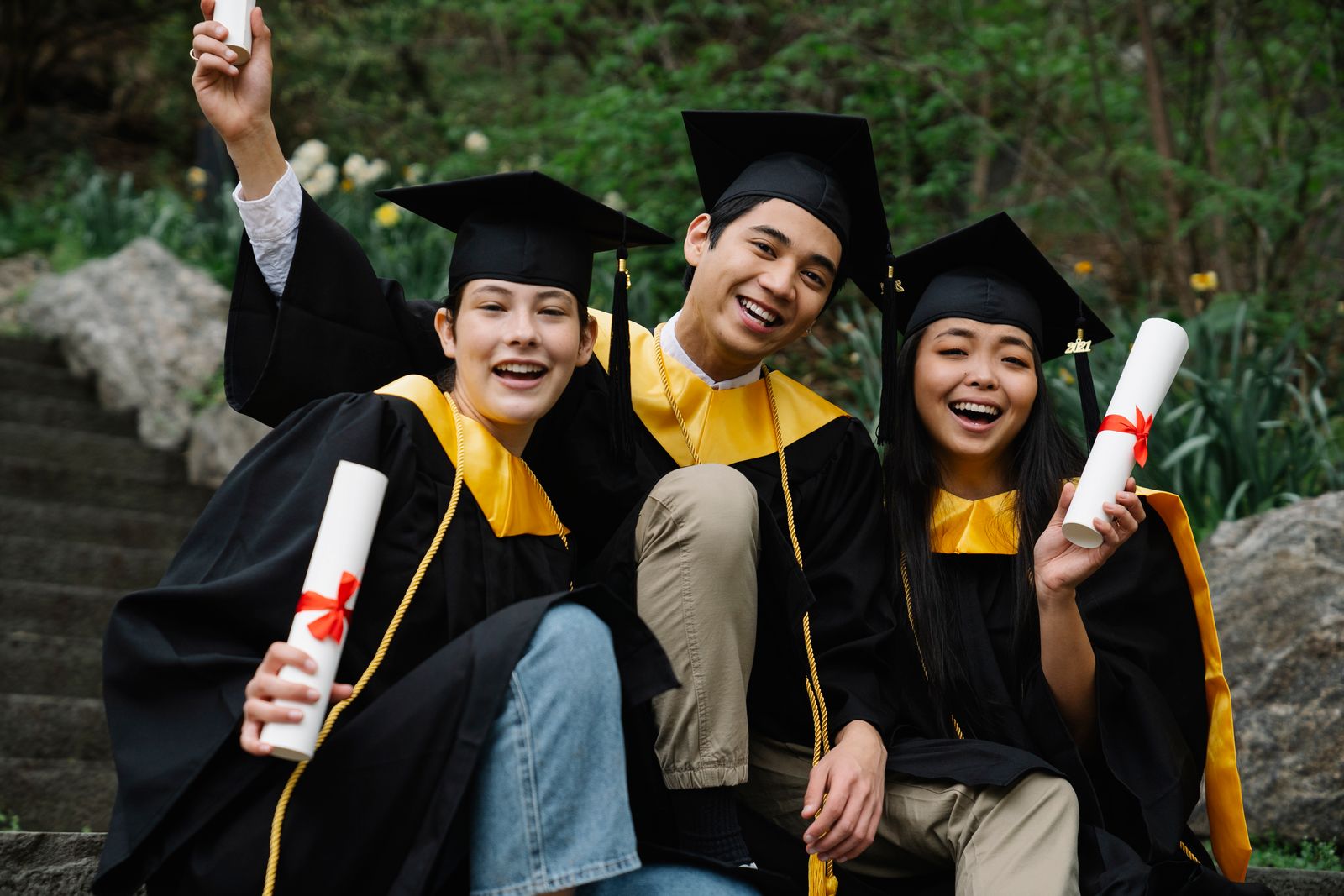 Graduates celebrating with diplomas