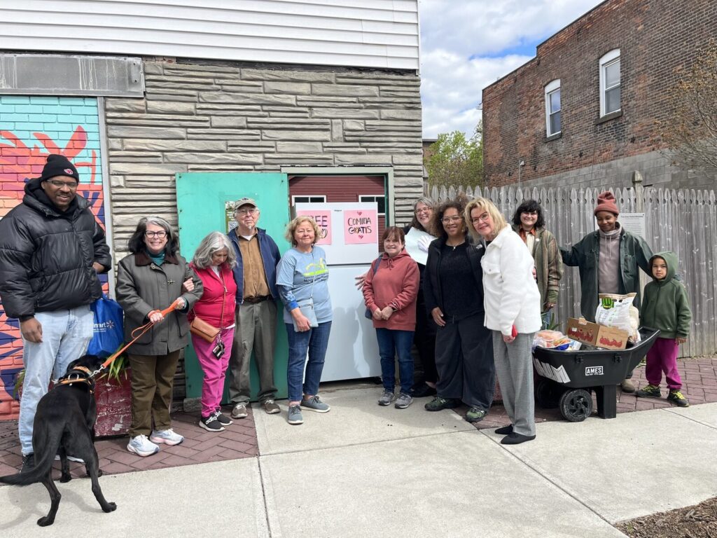 Neighbors and clergy gathered outside the Free Food Fridge on Second Street.