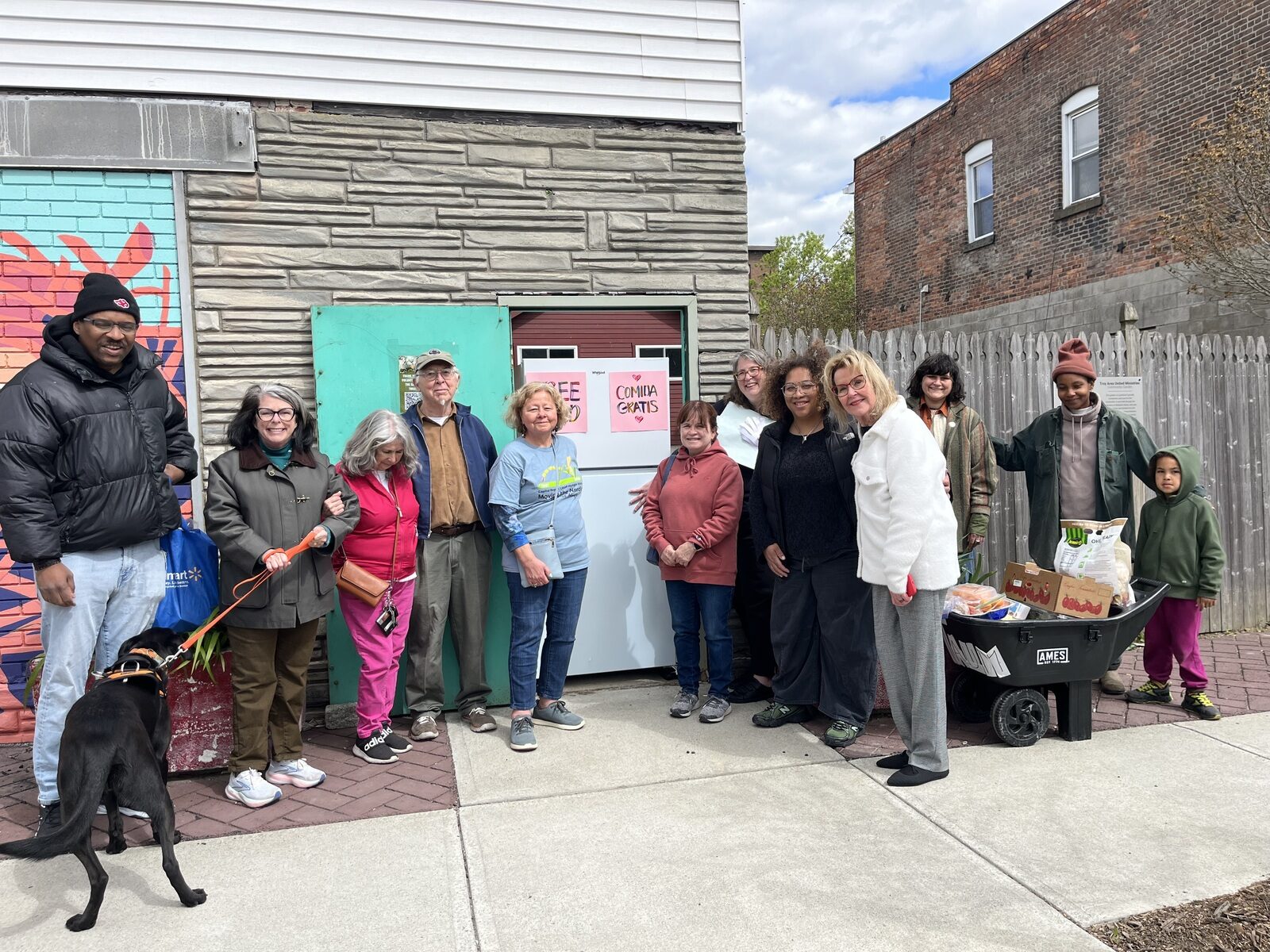 A group of neighbors and clergy gathered outside the Free Food Fridge on Second Street.