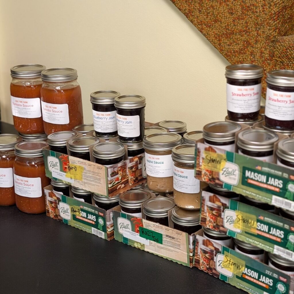 Jars of sauce and preserves made from the TAUM garden harvest.