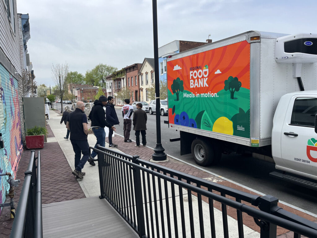 A Regional Food Bank "Meals in Motion" truck parked outside TAUM on Second Street.