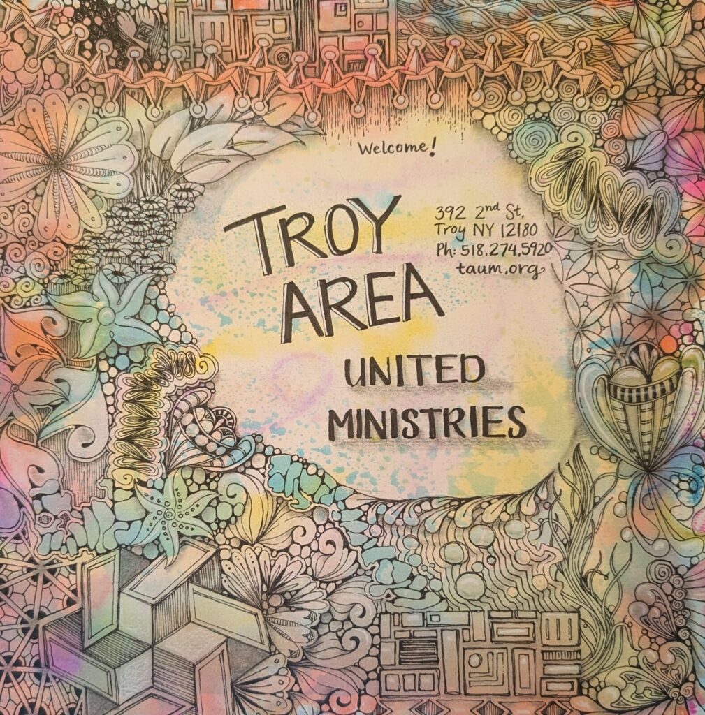 A hand-drawn welcome sign reading Troy Area United Ministries, 392 2nd Street, Troy NY.