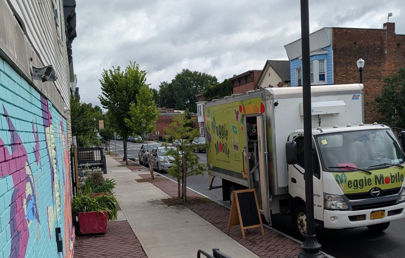 The Veggie Mobile truck parked on Second Street beside the TAUM mural.
